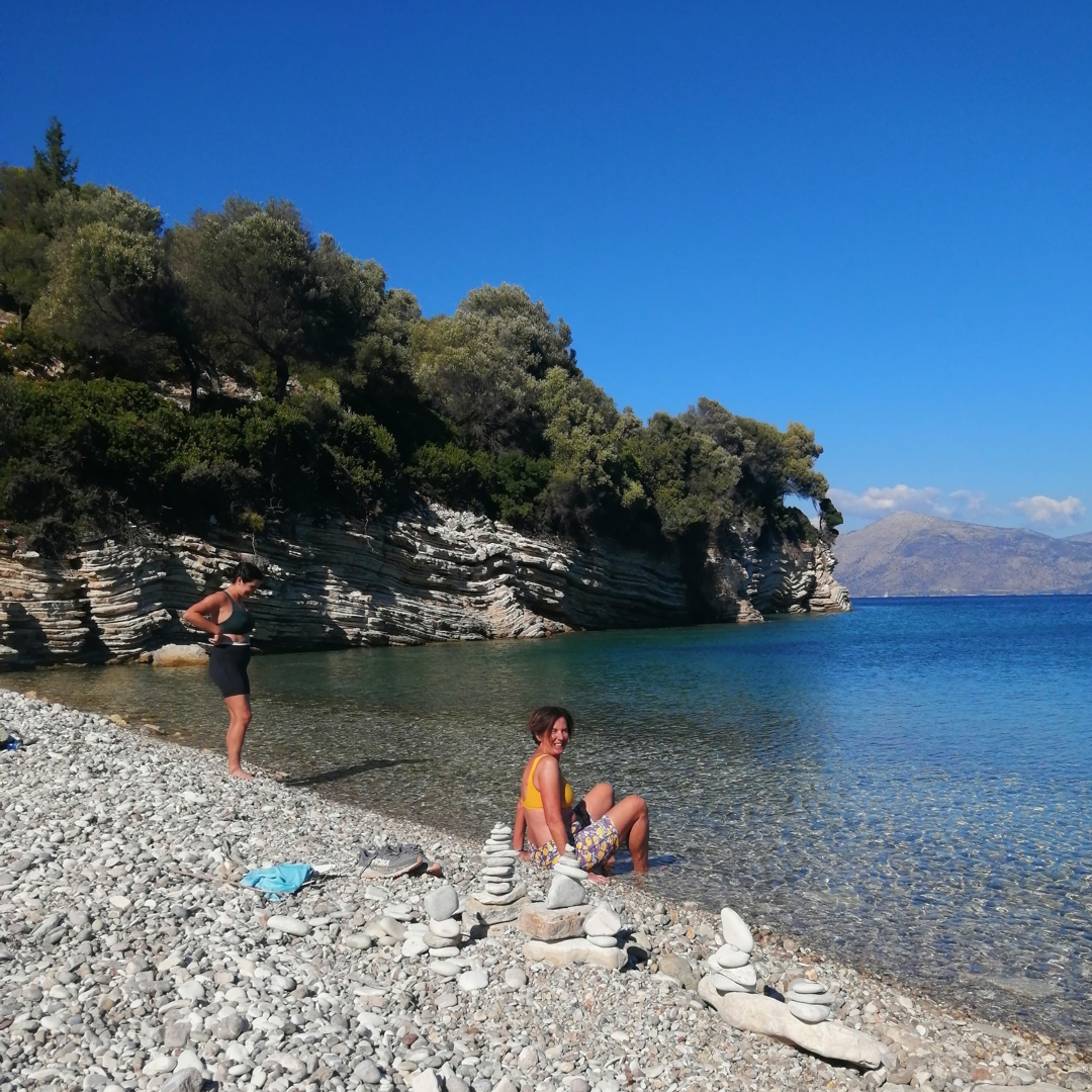 Catamaran JOY anchored in crystal-clear waters near Lefkada.