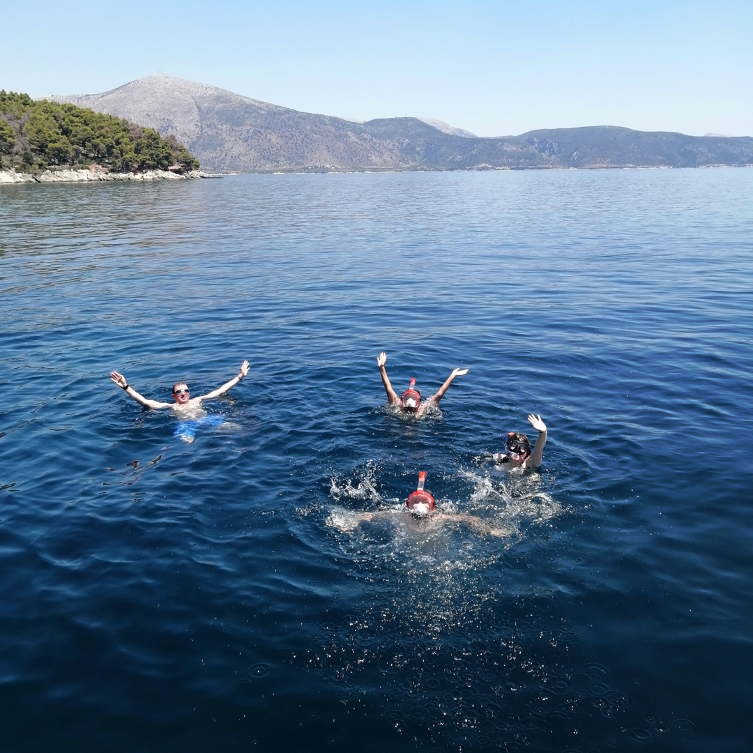 Catamaran JOY anchored in crystal-clear waters near Lefkada.