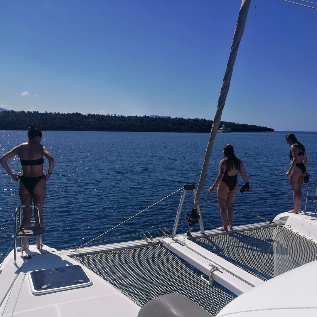 Jumping from the catamaran into the water.