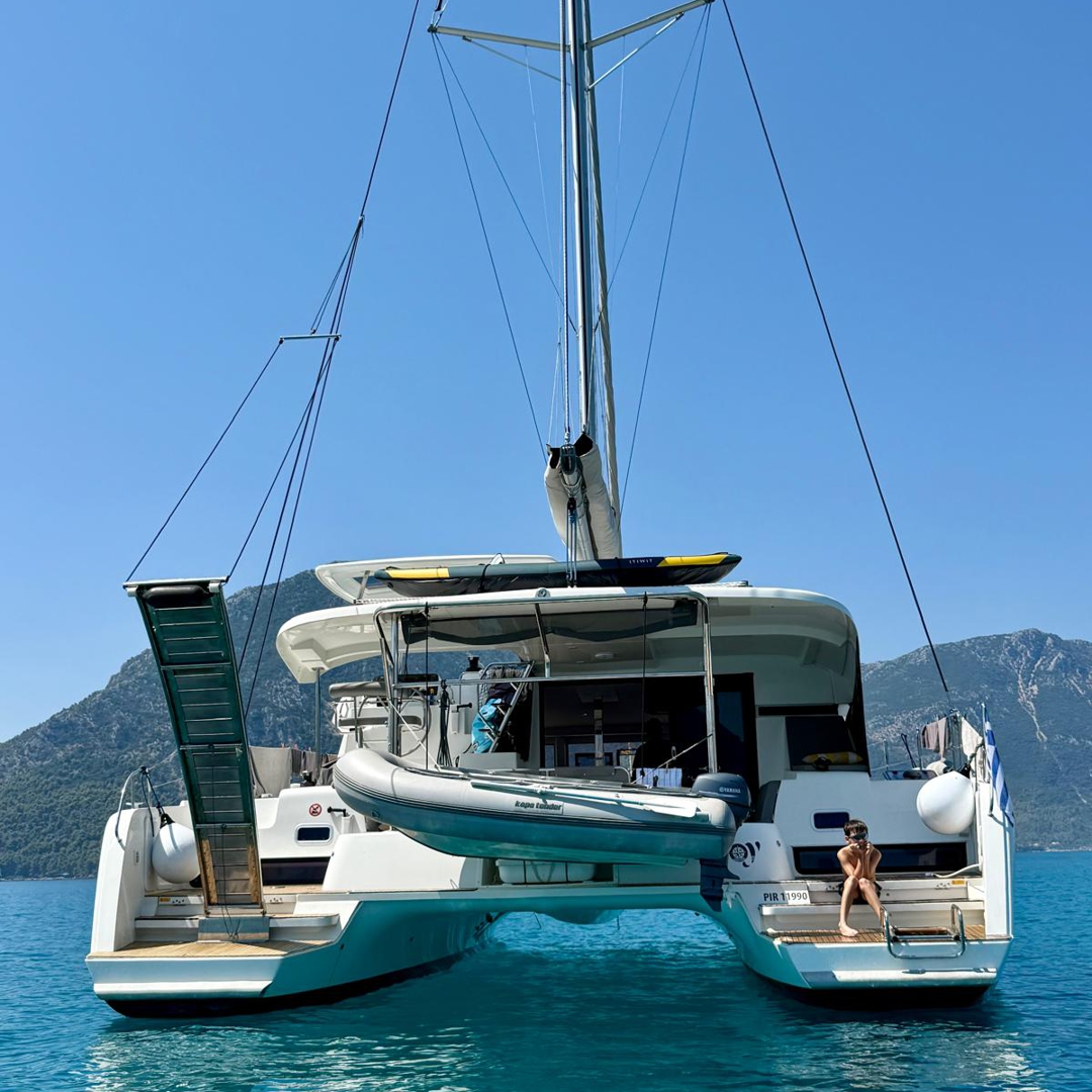 Catamaran JOY anchored in crystal-clear waters near Lefkada.